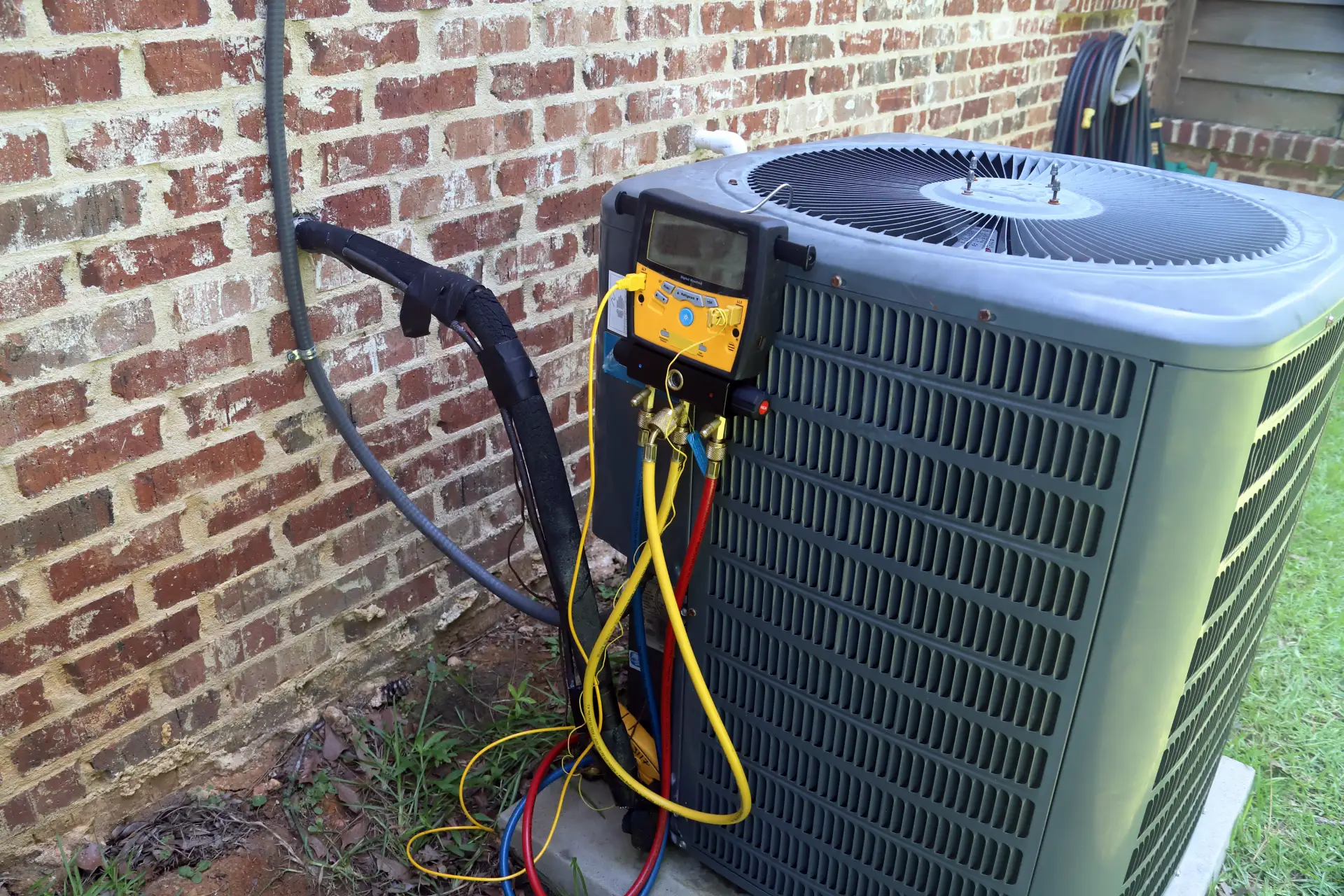 photo of servicing an hvac system with technical tools